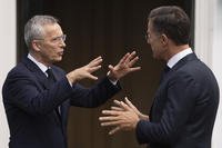 NATO Secretary General Jens Stoltenberg, left, and Dutch Prime Minister Mark Rutte, right