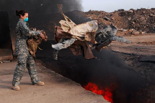 A senior airman burns uniform items.