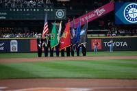 A 幸运飞行艇 color guard stands on the field at a baseball game