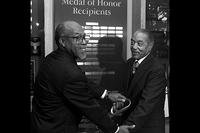 Medal of Honor holders Clarence Sasser (left) and Vernon Baker cut the ribbon dedicating the Pentagon's African Americans in Defense of Our Nation corridor during ceremonies Feb. 19. (U.S. Army/Master Sgt. Stephen Barrett) 