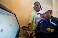 Ida Malone watches her husband, Navy Chief Petty Officer Averill Malone, as he checks for job offers in his email. Ida is also Averill’s caregiver who helps prevent him reacting to situations that could trigger his post-traumatic stress disorder. (Defense Department/EJ Hersom)